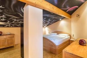 a bedroom with a bed in a room with a ceiling at Haus am Bächel in Lauf