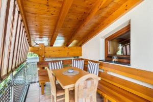 a dining room with a table and chairs on a balcony at Haus am Bächel in Lauf