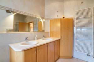 a bathroom with two sinks and a mirror at Haus am Bächel in Lauf +27 photos