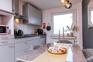 a kitchen with a table with a bowl of food on it at Melin Spa Suite – Wellness, Garten in Marl