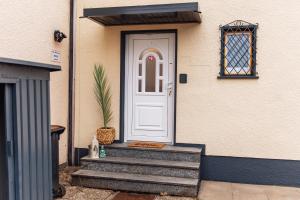 a white door on a house with stairs at Melin Spa Suite – Wellness, Garten in Marl