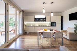 a kitchen and living room with a table and chairs at Casa Cenate in Nardò