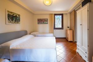 a bedroom with a white bed and a window at Casa Cenate in Nardò