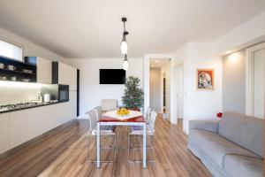 a kitchen and living room with a table and a couch at Casa Cenate in Nardò