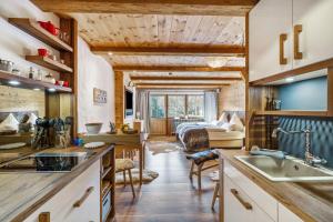 a kitchen and living room in a log cabin at Chalet Gipfelblick Inzell in Inzell