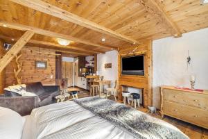 a bedroom with a bed and a living room at Chalet Gipfelblick Inzell in Inzell