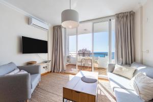 a living room with a couch and a tv at Apartamento Loli in Aguadulce