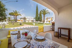 a dining room with a table and chairs on a balcony at Casa O12 in Vilamoura
