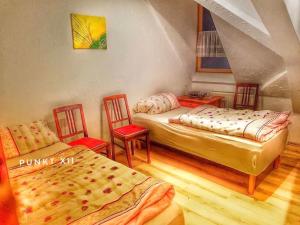 a room with two beds and two chairs in it at Wohnung 1 in Burghaslach