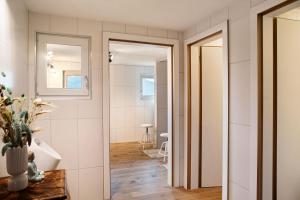 a bathroom with white walls and a doorway at Berghof Moosen in Hart im Zillertal +33 photos