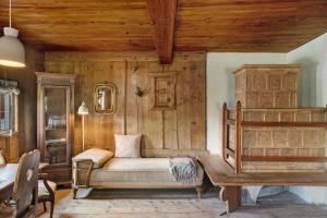 a bedroom with a bed and a wooden wall at Berghof Moosen in Hart im Zillertal