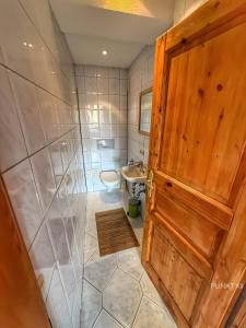 a bathroom with a shower and a toilet and a sink at Wohnung 1 in Burghaslach +21 photos