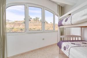 a bedroom with a bunk bed and a window at Apartamento Laolita in Torrox +25 photos