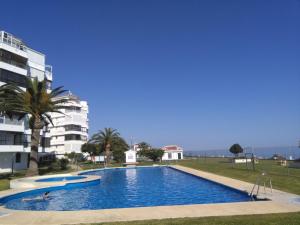 a large blue swimming pool next to a building at Apartamento Laolita in Torrox