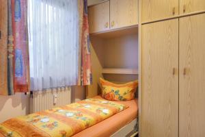 a small closet with a bed in a room at Ferienwohnung Wagner mit 35 qm Fr in Bad Bellingen