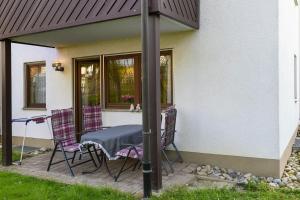 a patio with a table and chairs in front of a house at Ferienwohnung Wagner mit 35 qm Fr in Bad Bellingen