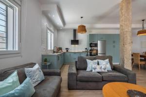 a living room with two couches and a kitchen at Villa Isla del Moral in Isla del Moral +7 photos