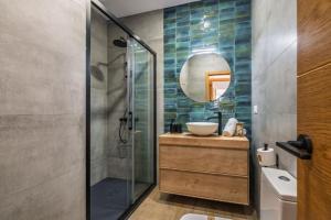 a bathroom with a sink and a glass shower at Villa Isla del Moral in Isla del Moral