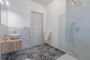 a white bathroom with a sink and a shower at New and Vintage Villa - Anni 50' in Alghero +22 photos