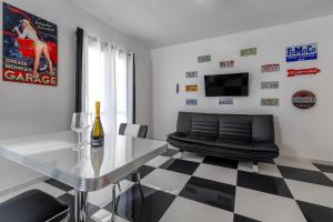 a living room with a glass table and a couch at New and Vintage Villa - Anni 50' in Alghero