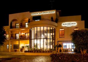 a large building with a clock on the front of it at Hotel Parque das Laranjeiras in Vilamoura