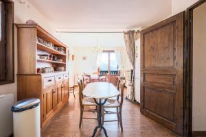 a kitchen with a table and chairs in a room at Chalet Jarrier 1400 in Jarrier