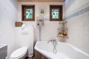 a bathroom with a tub and a toilet and a sink at Chalet Jarrier 1400 in Jarrier +26 photos