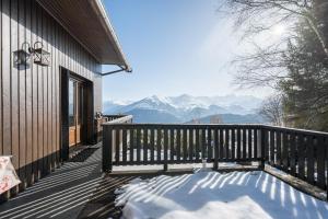 a snow covered porch with a view of mountains at Chalet Jarrier 1400 in Jarrier