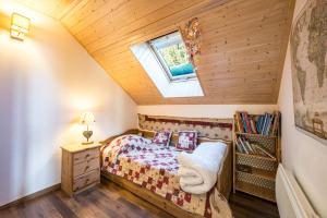 a small bedroom with a bed and a window at Chalet Jarrier 1400 in Jarrier