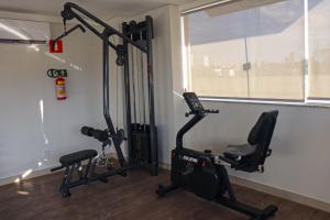 a gym with two exercise bikes and a window at LRFlat - Ambiente climatizado, moderno, confortável e próximo a tudo! in Montes Claros