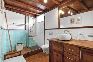 a bathroom with a sink and a toilet at El Portillo 1 in Buenavista del Norte +23 photos
