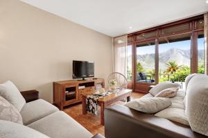 a living room with two couches and a tv at El Portillo 1 in Buenavista del Norte