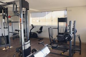 a gym with several exercise equipment in a room at LRFlat - Ambiente climatizado, moderno, confortável e próximo a tudo! in Montes Claros