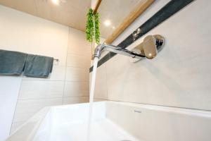 a bathroom with a bath tub with a faucet at Ferienwohnung Schwarzwald Penthus in Kappelrodeck +31 photos
