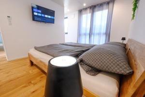 a bedroom with a bed and a tv on the wall at Ferienwohnung Schwarzwald Penthus in Kappelrodeck