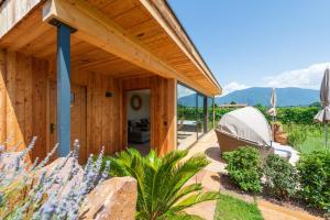 a wooden house with a garden and a boat on the porch at Weinangerhof St Pauls in Missiano
