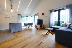 a living room with a couch and a table at Ferienwohnung Schwarzwald Penthus in Kappelrodeck
