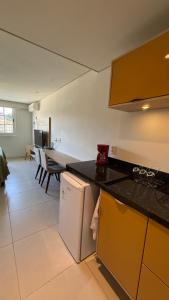 a kitchen with a counter top and a table at Granja Brasil , Studio Itaipava in Araras Petropolis +9 photos