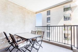 a balcony with a table and chairs on it at Valencia Playa in Valencia