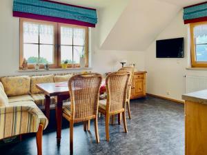 a living room with a table and chairs and a couch at Haus Rosenheim in Ramsau am Dachstein