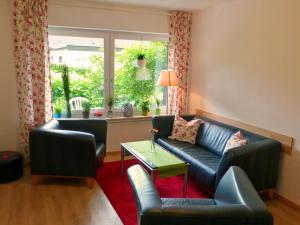 a living room with a couch and a table and a window at Ferienwohnung am Lerchenweg in Möhnesee