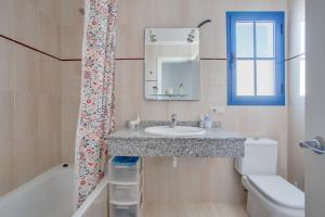 a bathroom with a sink and a shower curtain at Casa Rosa in Yaiza +12 photos