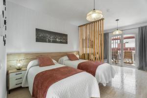 a bedroom with two beds in a room at Parque Carolina 208 in Costa Del Silencio