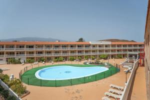 a large swimming pool in front of a hotel at Parque Carolina 208 in Costa Del Silencio