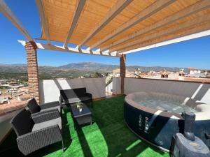 a hot tub on the roof of a house at Villa Cañete in Benamocarra