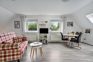 a living room with a couch and a table at Ferienhaus Dohle in Vollerwiek
