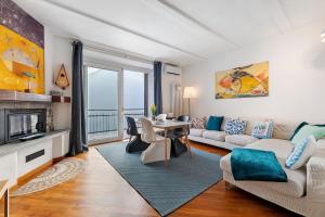 a living room with a couch and a table at La Gabbianella - Lake Como in Argegno