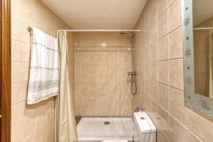 a bathroom with a shower and a toilet and a sink at Cal Tatanet in Sant Pau de Segúries +18 photos
