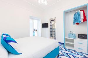 a white bedroom with a bed and a closet at Aurora Luxury Suites Seaview in Positano +47 photos