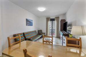 a living room with a table and a couch at Luján 1a Entre Hogueras Y Luces in Puntallana